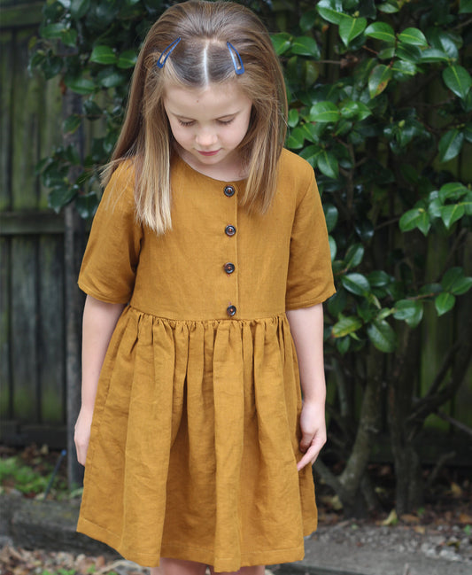 Below the Kōwhai Baby/Child Kauri Dress